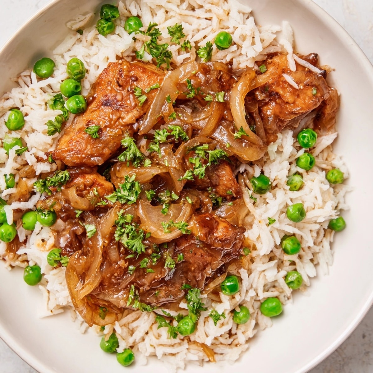 One-Pot Creamy Lemon Chicken and Rice served hot in a skillet, garnished with fresh parsley and lemon zest.