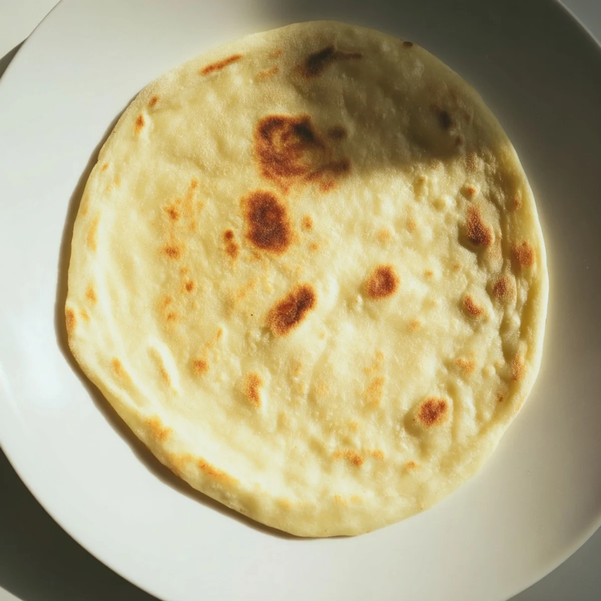 Golden-brown Three-Ingredient Easy Flatbreads, ready to tear open and enjoy with creamy dips.