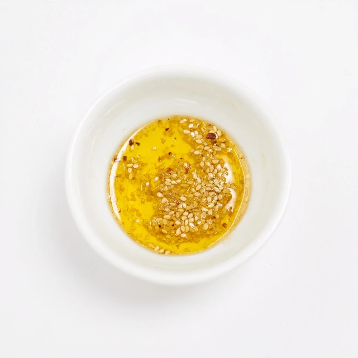 Golden-hued Simple Honey Vinaigrette Salad Dressing, perfectly emulsified, ready to be used on vegetables.
