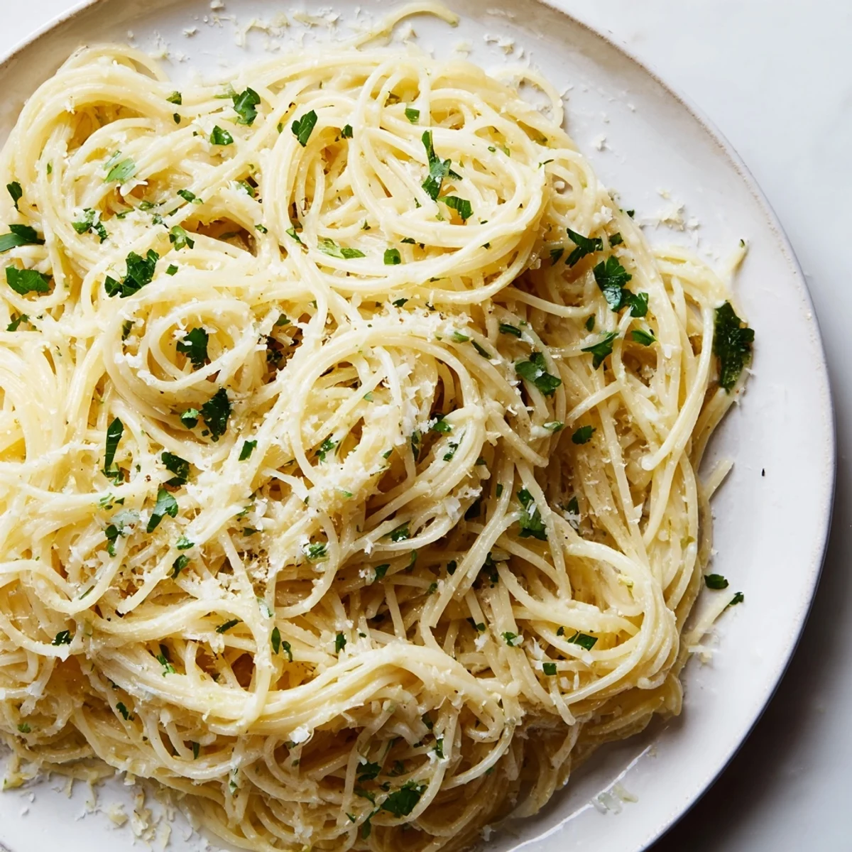 An overhead shot of Lemon Butter Pasta Light with silky sauce, lemon zest, and a sprinkle of black pepper for a refreshing finish.