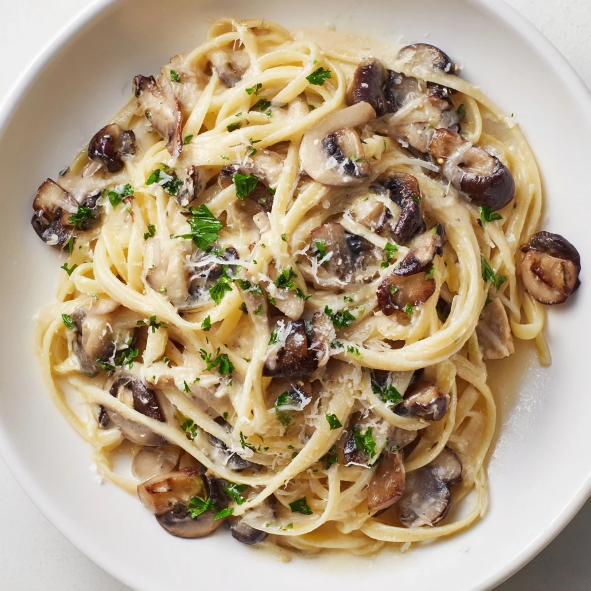 Tender linguine coated in a velvety cream sauce featuring earthy mushrooms, shallots, and a hint of black pepper.