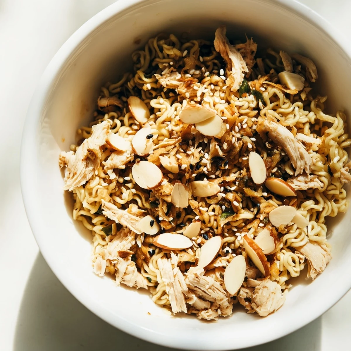 Crunchy ramen noodles and toasted almonds top this refreshing chicken salad, perfect for a quick lunch or a potluck side dish.