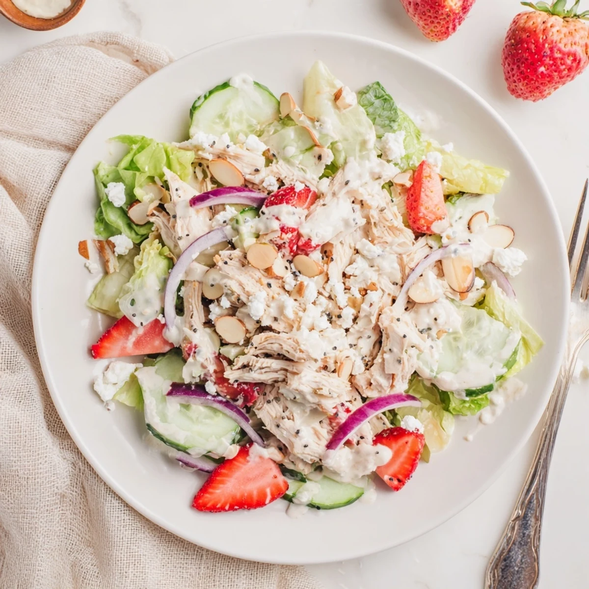 Light and refreshing Strawberry Poppy Seed Chicken Salad topped with crumbled feta and toasted almonds for extra crunch.