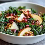Bright green kale salad mixed with sweet pomegranate arils, tart apple, and toasted walnuts tossed in tangy vinaigrette.