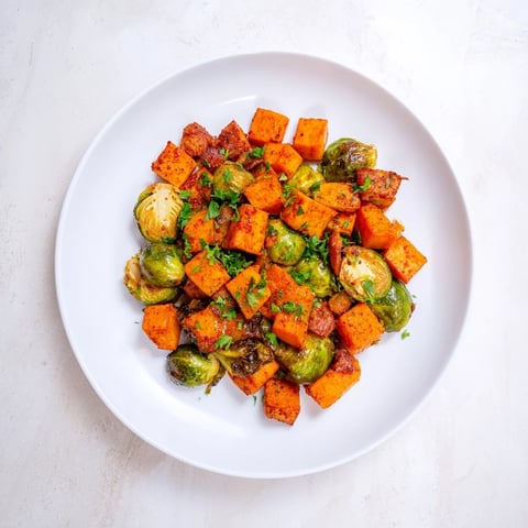 Vibrant sheet pan sausage, sweet potato, and Brussels sprouts, roasted to tender perfection, ready to serve.