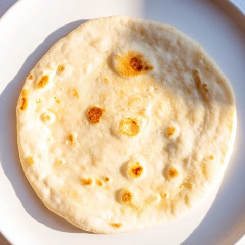 Warm, lightly charred Three-Ingredient Easy Flatbreads, perfect for scooping up a flavorful curry.