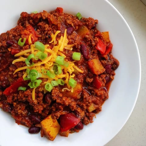 Deep, rich colors fill this photo of simple weeknight chili, ideal for a cozy dinner.