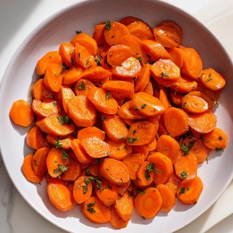 Golden Honey-Glazed Carrots: glistening, caramelized carrots with a sweet honey glaze, a visually appealing side.