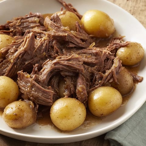 Fork-tender pot roast, perfectly slow-cooked for hours, showcasing a beautiful, savory aroma.