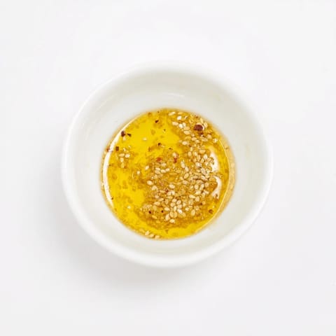 Golden-hued Simple Honey Vinaigrette Salad Dressing, perfectly emulsified, ready to be used on vegetables.