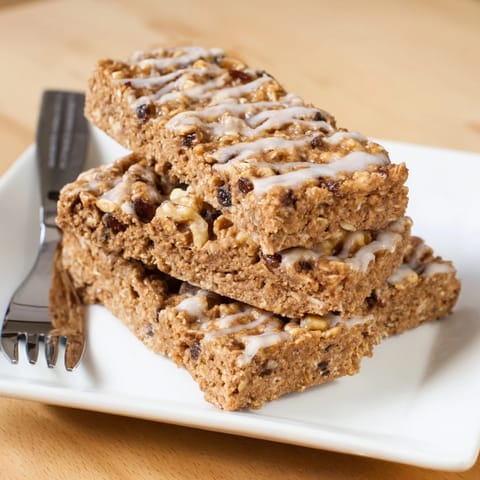 Freshly baked maple cinnamon oatmeal bars, with visible oats, ready to be enjoyed as a snack.