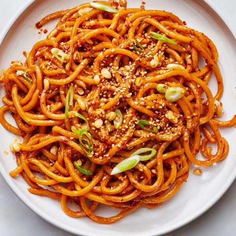 Bright, flavorful Garlic Chili Oil Noodles, coated in a glistening, bold chili oil sauce.