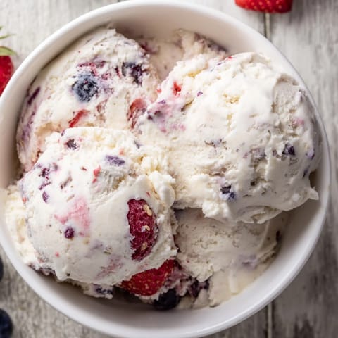 Silky smooth Cottage Cheese Ice Cream sprinkled with frozen berries, promising a cool and delicious bite.