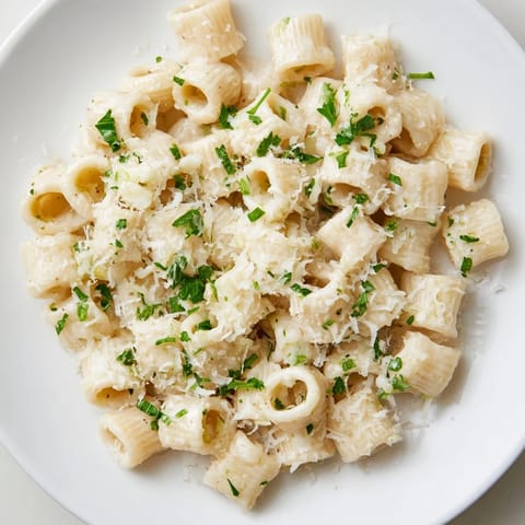 Golden, cheesy ditalini pasta coated in a creamy garlic sauce, perfect for a cozy dinner.