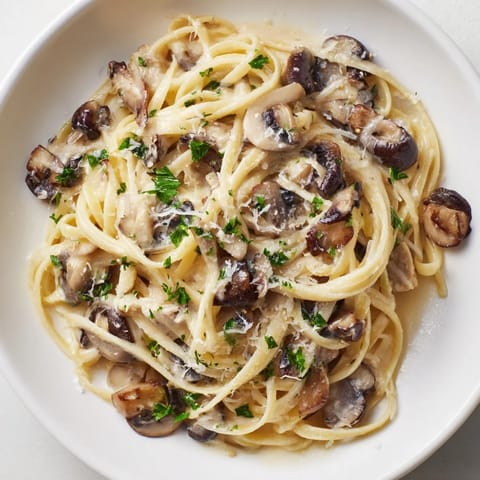 Tender linguine coated in a velvety cream sauce featuring earthy mushrooms, shallots, and a hint of black pepper.