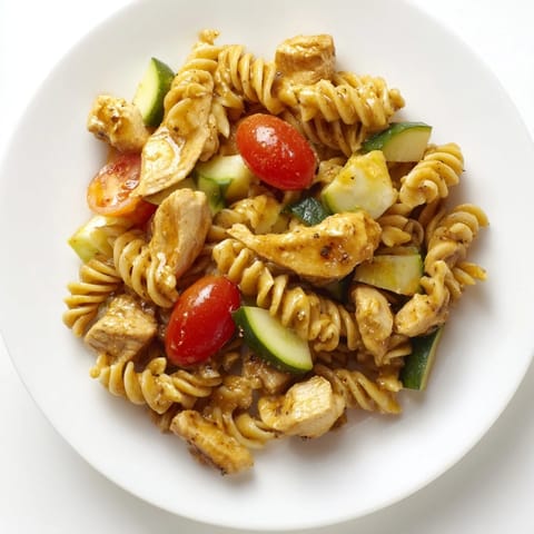 A refreshing bowl of Honey Mustard Chicken Pasta Salad, featuring juicy chicken, spiral pasta, and colorful vegetables, perfect for a light summer lunch.
