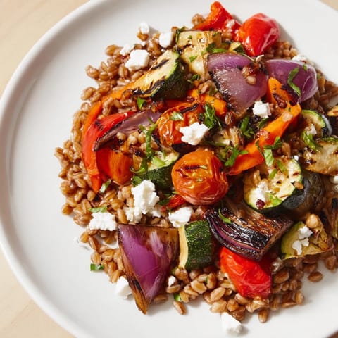 Farro With Roasted Vegetables served warm with fresh parsley, zucchini, and crumbled feta cheese. 
