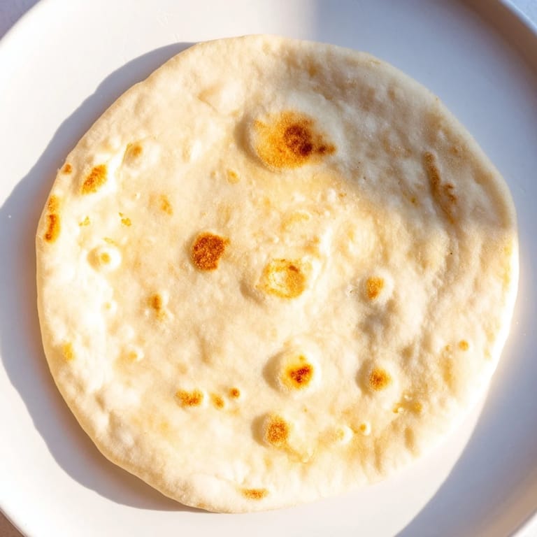 Warm, lightly charred Three-Ingredient Easy Flatbreads, perfect for scooping up a flavorful curry.