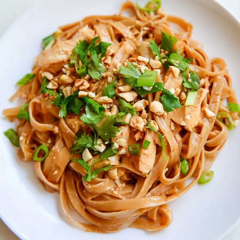 Creamy, flavorful Thai Peanut Chicken Pasta, showcasing tender chicken and a rich, peanut-infused sauce.