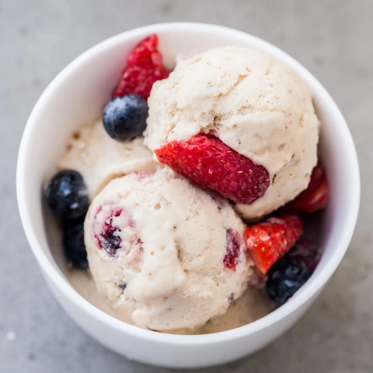 Freshly made Cottage Cheese Ice Cream featuring a sweet, berry swirl, perfect for a refreshing dessert.