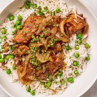 One-Pot Creamy Lemon Chicken and Rice served hot in a skillet, garnished with fresh parsley and lemon zest.