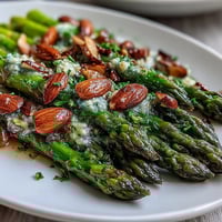 Bright lemon butter asparagus with toasted almonds, perfect for spring celebrations and elegant side dishes.